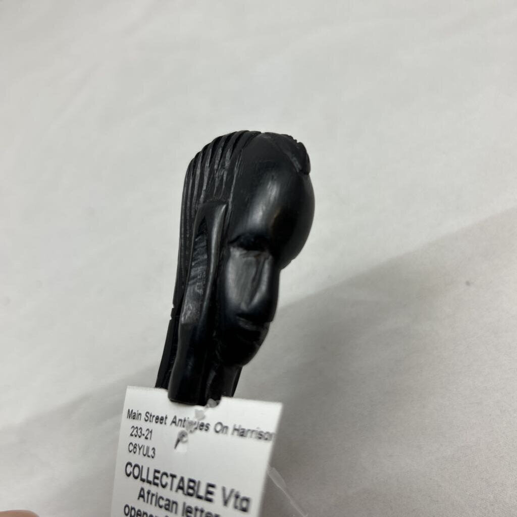 Vtg African letter opener featuring a dark wood handle hand-carved into a tribal head design.