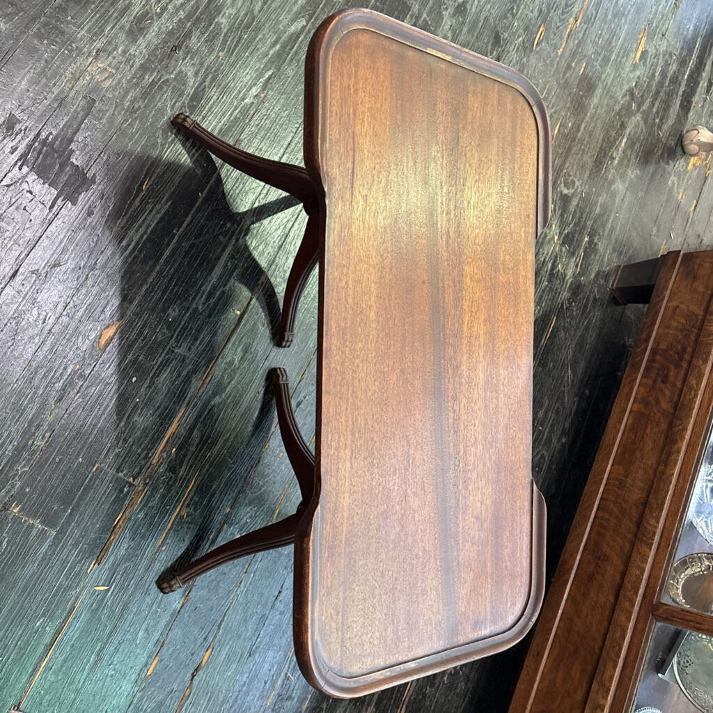 Mahogany Sheridan revival coffee table with partial gallery edged top and a double tripod base; circa 1930-50