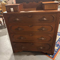 Victorian walnut chest of drawers; step back top with glove drawers, and heavily carved pulls. Circa 1870s