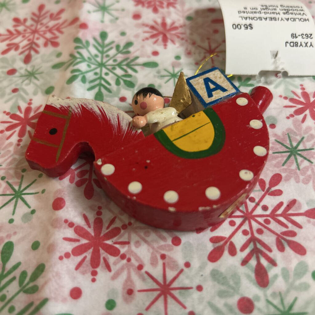 Vintage Hand-painted wooden angel on a rocking horse.