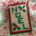 Handmade needlepoint "noel" Christmas ornament.