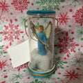 Baby angel inside clear cylindrical jar ornament, Christmas.