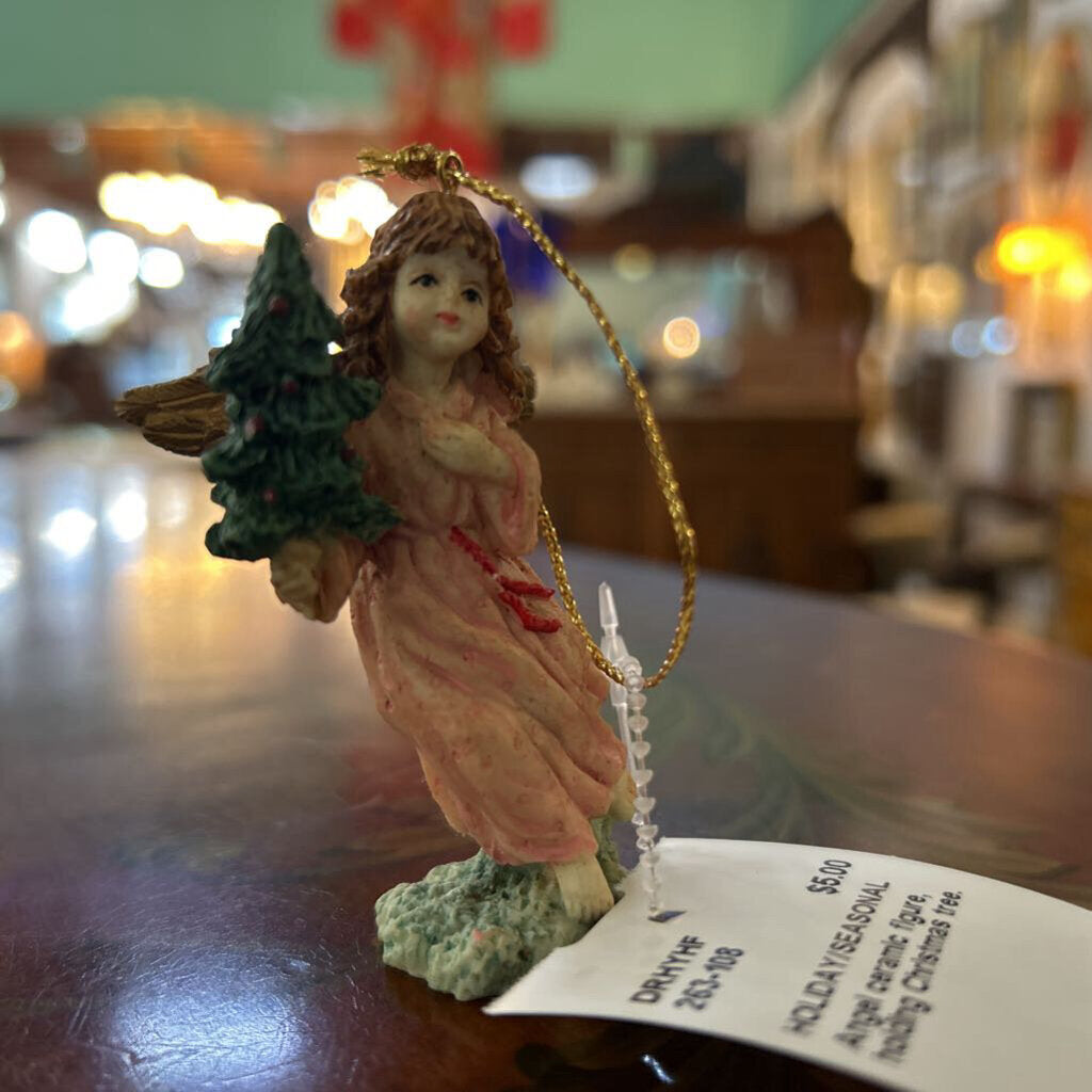 Angel ceramic figure, holding Christmas tree.
