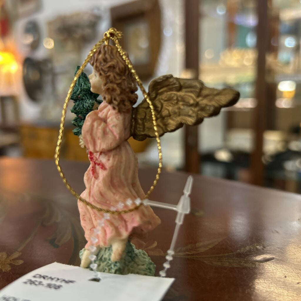 Angel ceramic figure, holding Christmas tree.