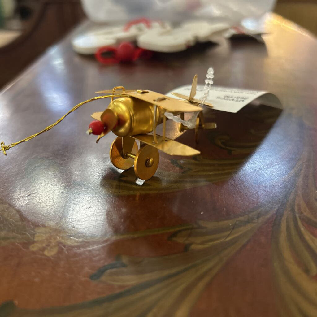 Vintage metal airplane ornament gold brass color.