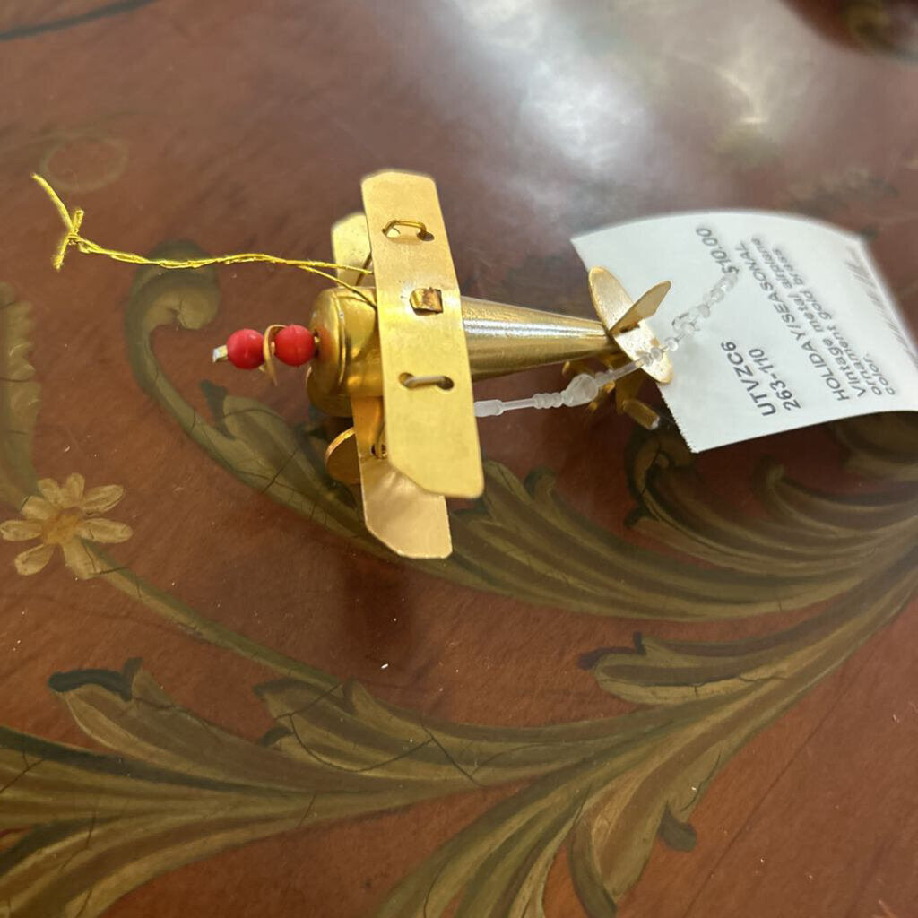 Vintage metal airplane ornament gold brass color.
